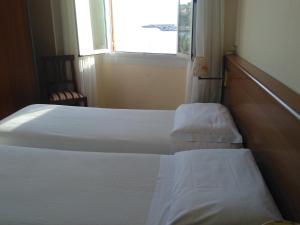 Rúm í herbergi á Albergo Bandoni