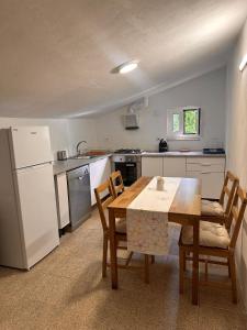 a kitchen with a table and chairs and a refrigerator at Lake House Gerês in Admeus