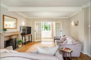 a living room with two couches and a fireplace at Dalforth Thaxted Barn Collection in London Stansted Airport