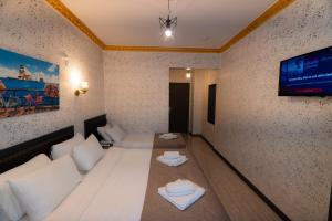 a living room with a couch and a tv on the wall at Golden Horn Life Hotel- FULL BOARD in Istanbul