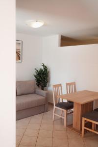 a living room with a couch and a table at OLIVE in Nerezine