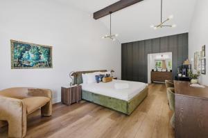 a bedroom with a bed and a couch and a chair at The Warren Hotel in Bridgman +23 photos