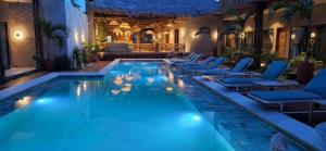 a swimming pool with lounge chairs and a hotel at Be caju flats in Barra Grande