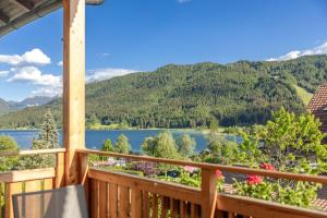 a view from the deck of a cabin overlooking a lake at Haus Lackner am Weissensee in Kärnten in Weissensee