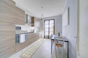 a kitchen with a table and a stove top oven at Villa dante in Alba +21 photos