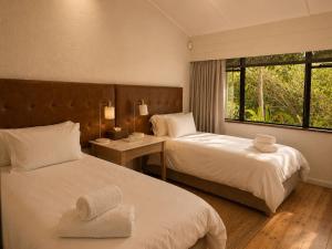 a hotel room with two beds and a window at Twice Central Guest House in Stellenbosch +55 photos