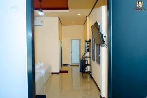 a hallway of a bathroom with a tub and a sink at Limlay House in Ban Suan On