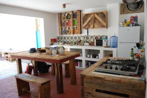 a kitchen with a table and a stove top oven at La Choza Guesthouse in Santo Domingo