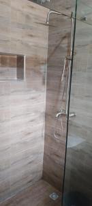 a shower with a glass door in a bathroom at Skyline Apartments in Lagos +14 photos