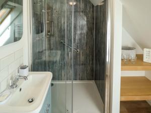 a bathroom with a shower and a sink at Bobblehat Barn in Alford +29 photos