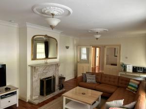 a living room with a couch and a fireplace at The Sanctuary in Killavullen