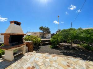 an outdoor pizza oven sitting on top of a patio at Casa VEROLES in Tías