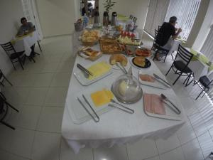 a table with a buffet of food on it at Dumont Park Hotel in Sao Jose do Rio Preto