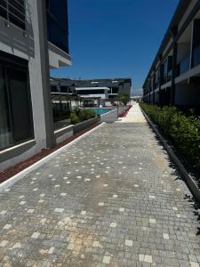 a cobblestone street next to a building at Mertcan Doruk in Side
