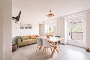 a living room with a table and chairs and a couch at Chez Mémé in Engenthal