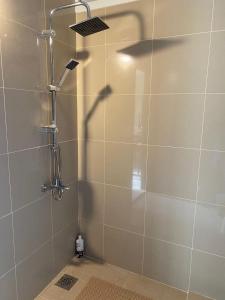 a shower with a glass door with a shower head at Chalet 102 - Zresidence - Faitroun in Al ‘Aqabah +8 photos