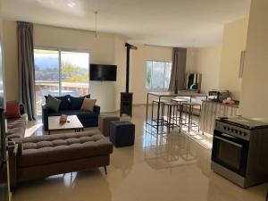 a large living room with a couch and a kitchen at Chalet 102 - Zresidence - Faitroun in Al ‘Aqabah