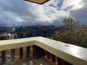a balcony with a view of a city at Chalet 102 - Zresidence - Faitroun in Al ‘Aqabah
