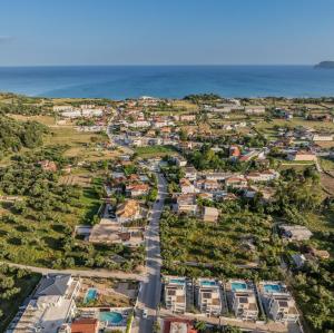 an aerial view of a town with the ocean at Villa V - Infinity Holiday Villas, For Large Groups With Private Pool, by ZanteWize in Kalamaki