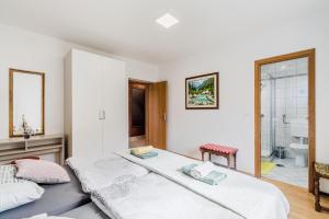 a bedroom with two beds and a bathroom at Apartma Jager in Bovec
