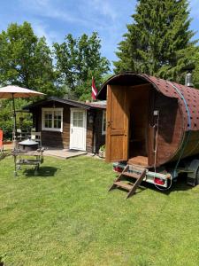 a small house with a boat on a trailer at Bungalo in Jūrmala