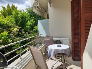 a balcony with a table and chairs on it at Vagionia Apartments in Ancient Epidauros