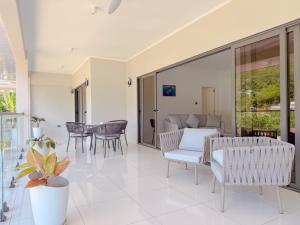 a living room with chairs and a table at Cove Holiday Apartments in Bel Ombre
