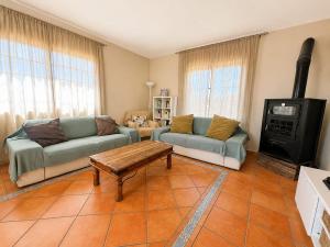 a living room with two couches and a wood stove at Casa VEROLES in Tías