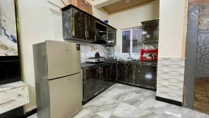 a kitchen with a stainless steel refrigerator and cabinets at 2 Bed Apartment With View in Patriata