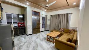a living room with a couch and a table at 2 Bed Apartment With View in Patriata +4 photos