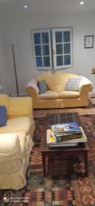 a living room with two couches and a coffee table at Les Ouilerres in Mervent