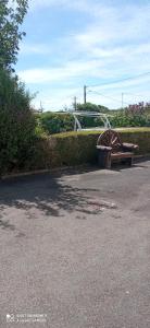 a park with a wooden bench and a bridge at Les Ouilerres in Mervent