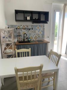 a kitchen with a white table and chairs at Ca' Salino in Villa Inferno +37 photos