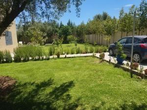 a yard with a car parked in a driveway at Dar Zaytouna in Oulad Akkou