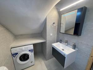 a bathroom with a washing machine and a sink at Paros Beach Studio Casa Costa Oro in Chrissi Akti +49 photos