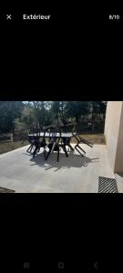 a row of picnic tables sitting on a sidewalk at Charmante maison in Sussac +2 photos