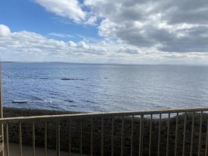 a view of the ocean from a balcony at Harbour Point Apartment in Saltcoats