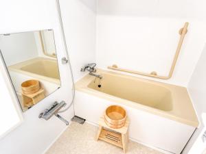 a bathroom with a tub and a sink at The Little Kamakura Hotel 鎌倉駅徒歩2分 in Kamakura +29 photos