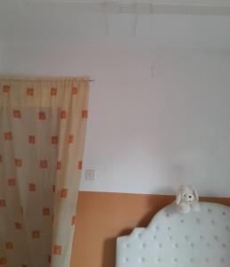 a room with a white curtain and a white table at WF&DGS Care LODGE in Owerri