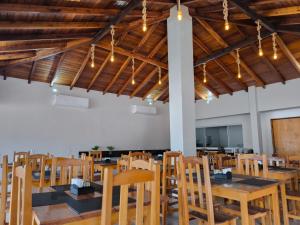 a dining room with wooden tables and chairs at HOTEL TROPICAL in Jardim