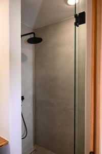 a shower with a glass door in a bathroom at Nevo Mykonos in Mikonos