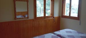 a bedroom with three windows and a bed in it at villa Garibaldi in Agüero