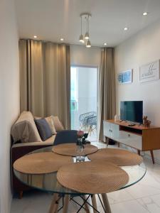 a living room with a couch and a table at Apartamento Frente Mar in Jacumã