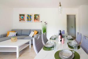 a living room with a table and a couch at Vacation apartments Mario with salt water pool in Turjaci