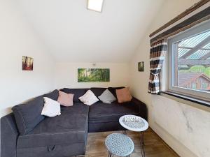 a living room with a couch and a window at Apartment Petra by Interhome in Grafenwiesen