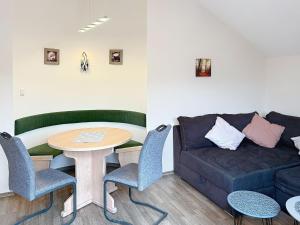 a living room with a couch and a table at Apartment Petra by Interhome in Grafenwiesen