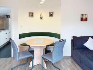 a living room with a table and chairs and a couch at Apartment Petra by Interhome in Grafenwiesen +22 photos