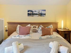 a bedroom with a large bed with two chairs at Apartment Petra by Interhome in Grafenwiesen