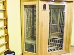 a wooden cage with two glass doors in a room at Villa Forestside Villa by Interhome in Planá nad Lužnicí