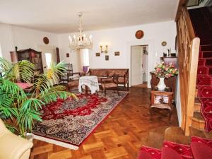 a living room with a chandelier and a living room at Villa Forestside Villa by Interhome in Planá nad Lužnicí +22 photos